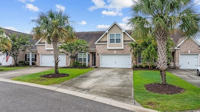 View of front of house with concrete driveway, a front yard, brick siding, and a garage