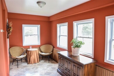 The enclosed porch is full of natural light with r