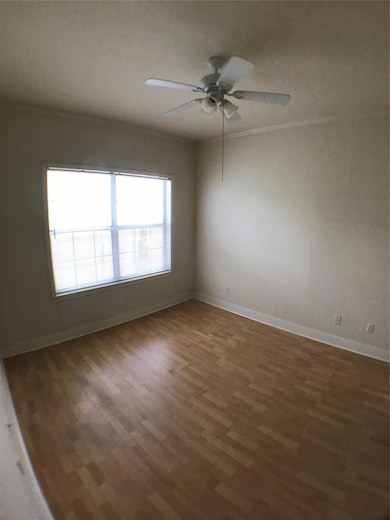 Spare room featuring ceiling fan, baseboards, and