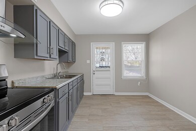 Kitchen with electric stove, wall chimney range ho