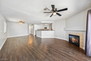 Unfurnished living room with a ceiling fan, a fire