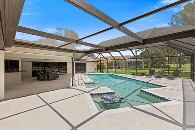 Large covered lanai and pool overlooking golf cour