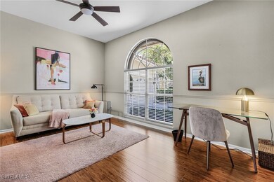 Living room featuring ceiling fan and wood finishe