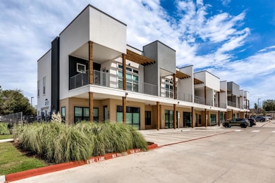 View of building exterior with uncovered parking