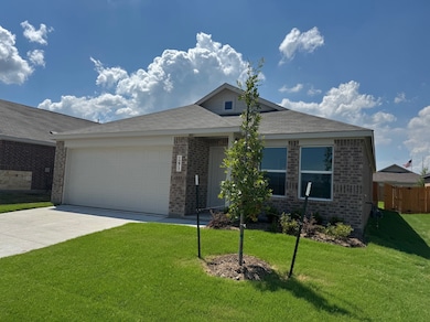 View of front of home featuring concrete driveway, brick siding, and a garage