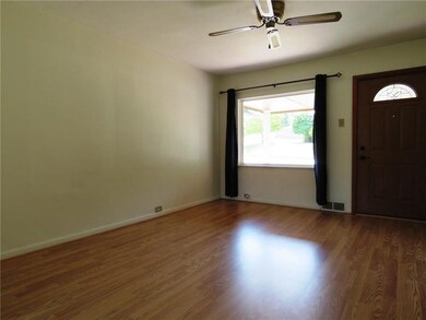 Spacious living room with updated flooring.  The l