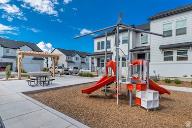 Community play area with a residential view and a pergola
