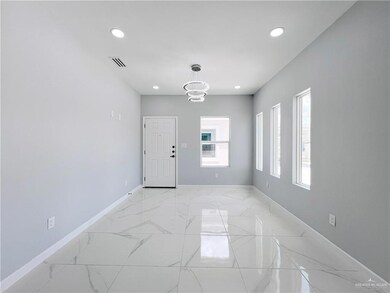Foyer entrance with recessed lighting, a chandelier, and light marble finish floors