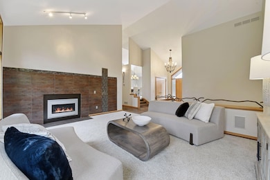 Host memorable gatherings in this inviting living room, featuring a cozy gas fireplace