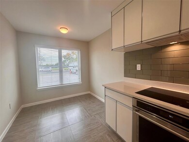 Kitchen featuring stainless steel oven, black ele