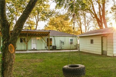 Backyard with tire swing, detached garage and larg