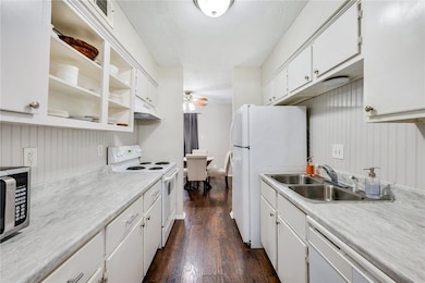 Kitchen with a ceiling fan, white appliances, ligh
