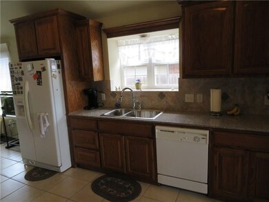 Kitchen features marble tile backsplash