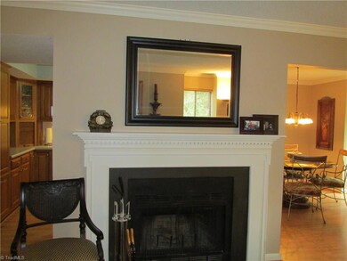 Fireplace wall separates the Kitchen and Dining room areas.