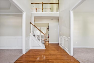 Foyer entrance featuring stairs, a decorative wall