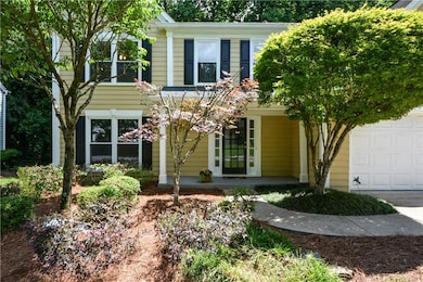 View of front of property with covered porch and an attached garage