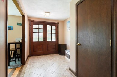 Foyer with mahogany double door and tle foyer