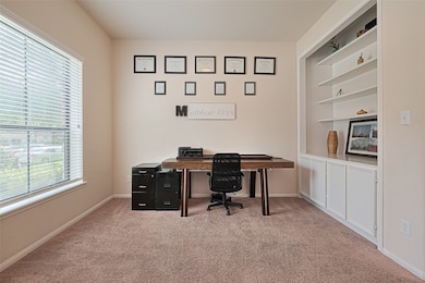 This photo features a cozy home office with a larg