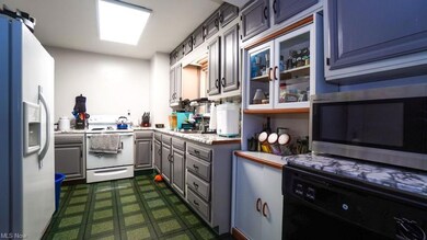 Kitchen featuring white range with electric stovet