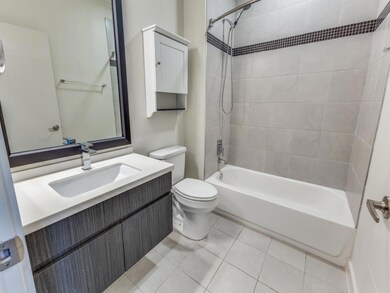 Bathroom with tile patterned floors, shower / bat