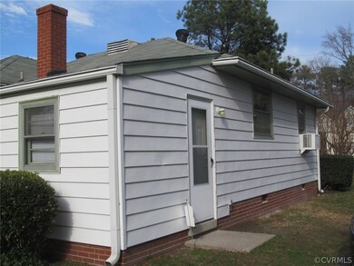 Left side of home with side entry from blacktop driveway directly into mud/utility room.
