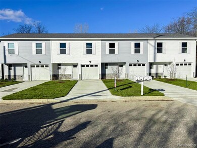 View of front of house featuring a front yard and concrete driveway