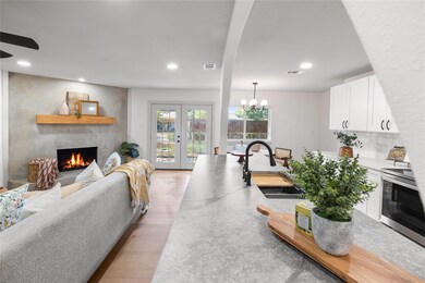 Living room with sink, light wood-type flooring, a