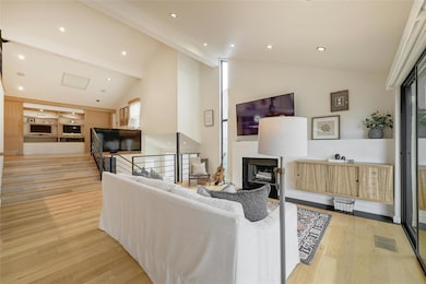 Living room featuring high vaulted ceiling, visib