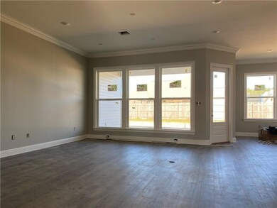 Living area w/ wall of cased in windows.