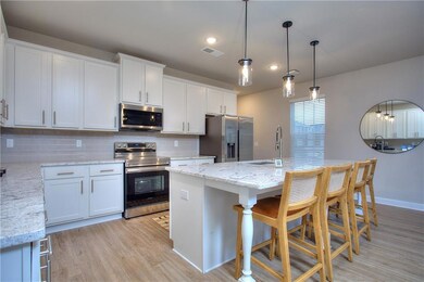 Kitchen featuring a kitchen bar, tasteful backspla