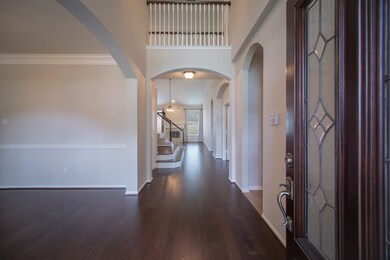 Welcoming entry highlighting the handsome wood flooring leading you straight to the heart of the home.