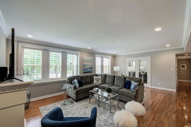 Light filled, spacious living room with fireplace.  This Bassett Sectional Sofa is included with the home!