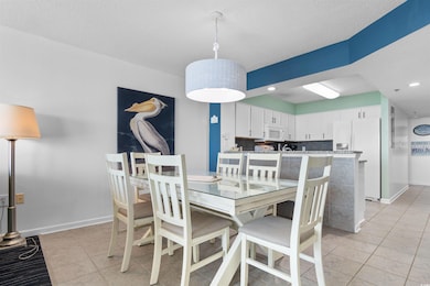 Dining area featuring light tile patterned flooring, recessed lighting, and a textured ceiling