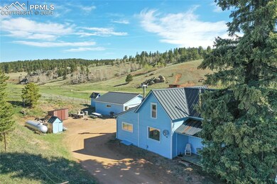Birds eye view of property featuring a rural view