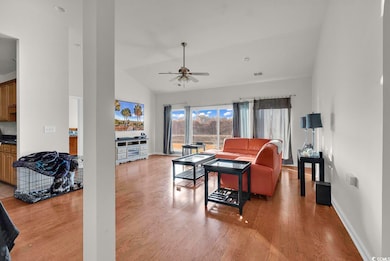 Living room featuring baseboards, wood finished fl