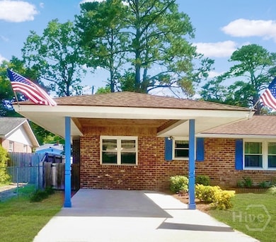 The carport & parking pad comfortably accommodate