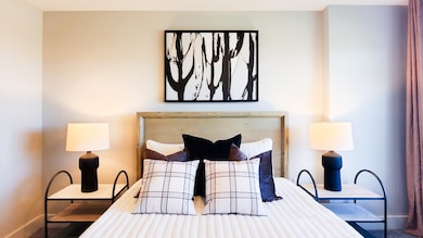 Bedroom featuring baseboards and carpet