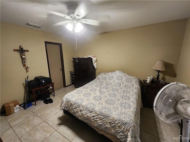 Bedroom featuring light tile patterned flooring and a ceiling fan