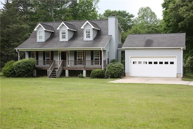 Cape cod-style house with a chimney, a porch, a sh