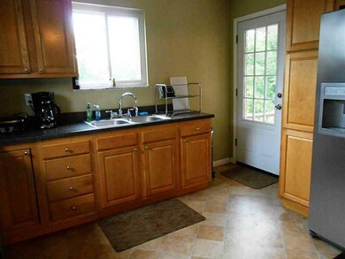 Kitchen. Access the partially covered rear porch/d