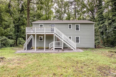 Back of house featuring stairway, a wooden deck, a