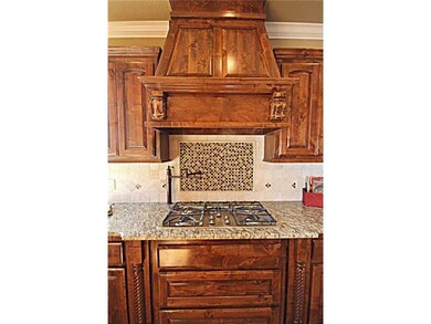 Kitchen. Granite countertops with gorgeous backsplash. 5 burner cooktop and pot filler