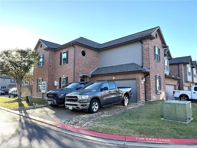 View of front of house with brick siding, a front lawn, and driveway