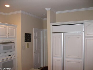 Kitchen - Custom white cabinets, covered refrigera