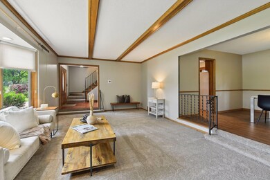 Natural Wood Beams in this Cozy Sunken Living Room