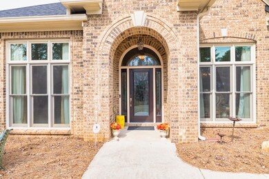Doorway to property with brick siding and roof with shingles