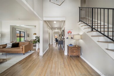 Inviting foyer features white oak floors, soaring