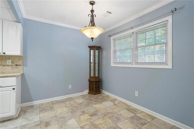 Unfurnished dining area with crown molding