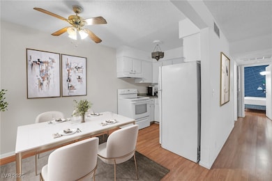 Kitchen with white appliances, under cabinet range