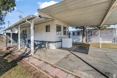 Exterior space featuring a carport and fence